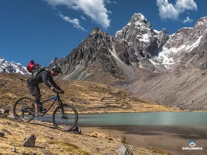 Mountain bikers riding across the open grassland of the Deosai plains