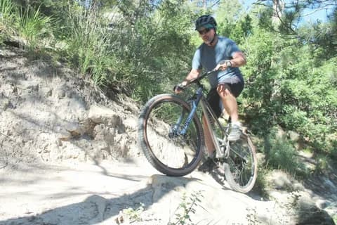 A mountain bike on a trail overlooking Hindu Kush valleys