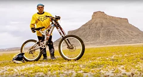 Mountain bikers riding through a village in the Hindu Kush