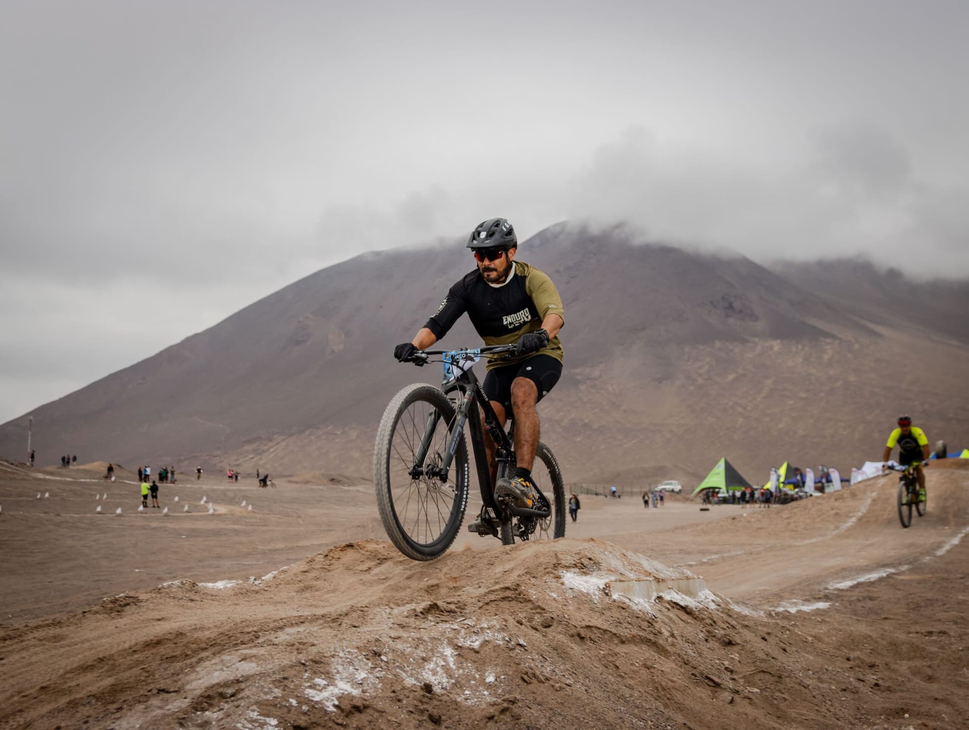 A cyclist riding through a mountain valley